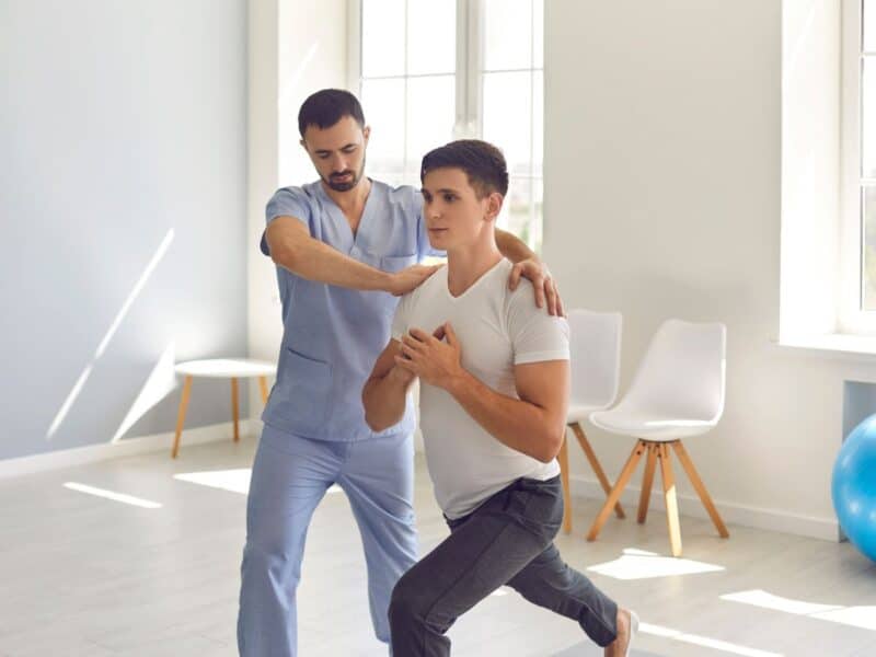 A physiotherapist helping the patient